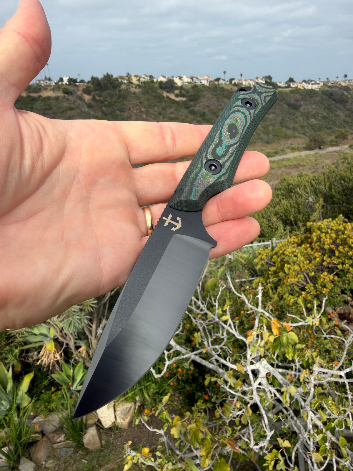 Leucadia Blade Co LandShark Kelp Bed CamoCarbon Black DLC in hand, showing the compact size and Kelp Bed CamoCarbon handle