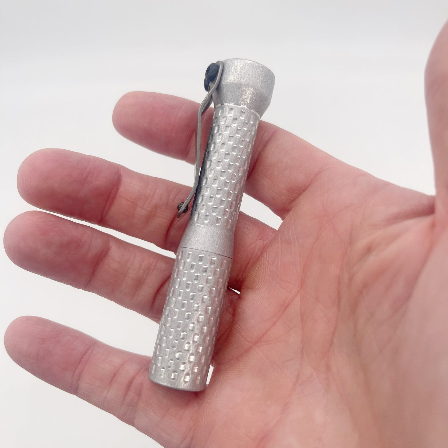 Dawson Machine Craft Divot Slimmer Aluminum EDC Flashlight – Tumbled Finish, 10440 Button Top In Hand