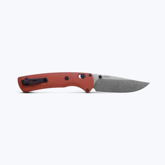 Red handle folding knife with open gray blade