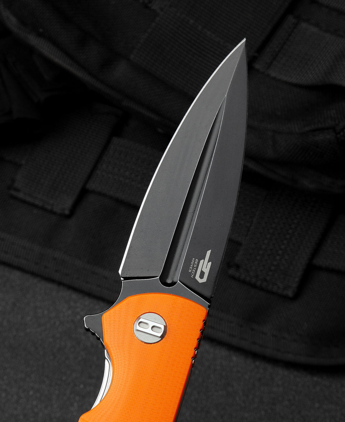 Bestech FIN BG34B-3 handle detail – orange G10 scales, liner lock, ceramic pivot