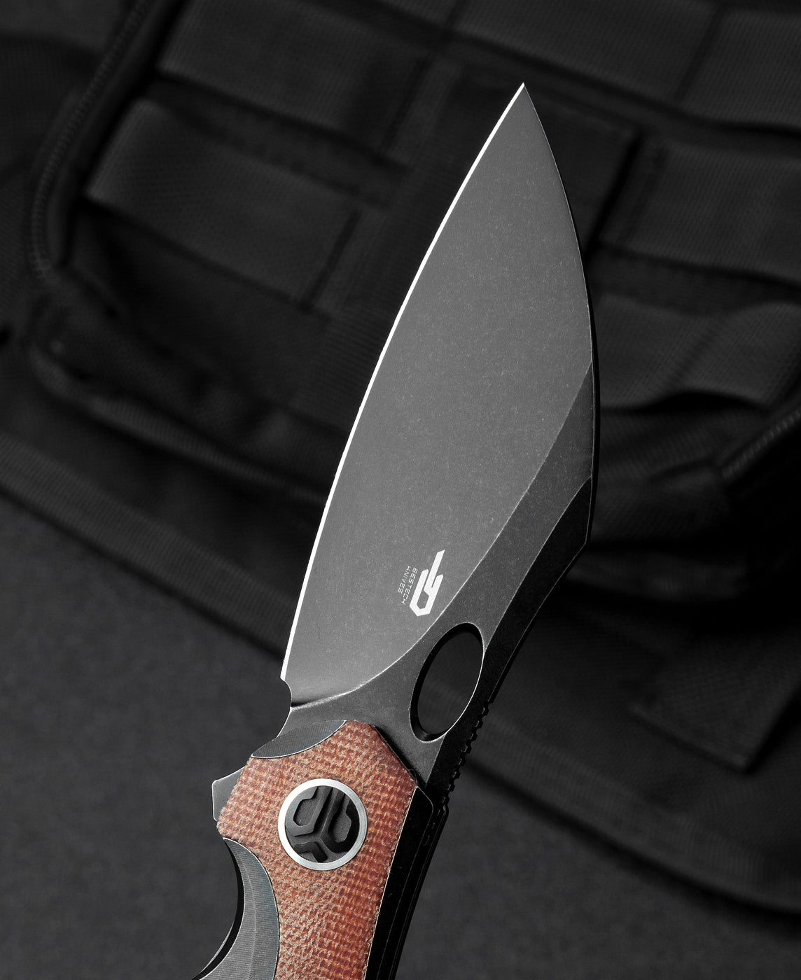Bestech Nogard BT2105E handle detail – black titanium and natural canvas micarta texture contrast