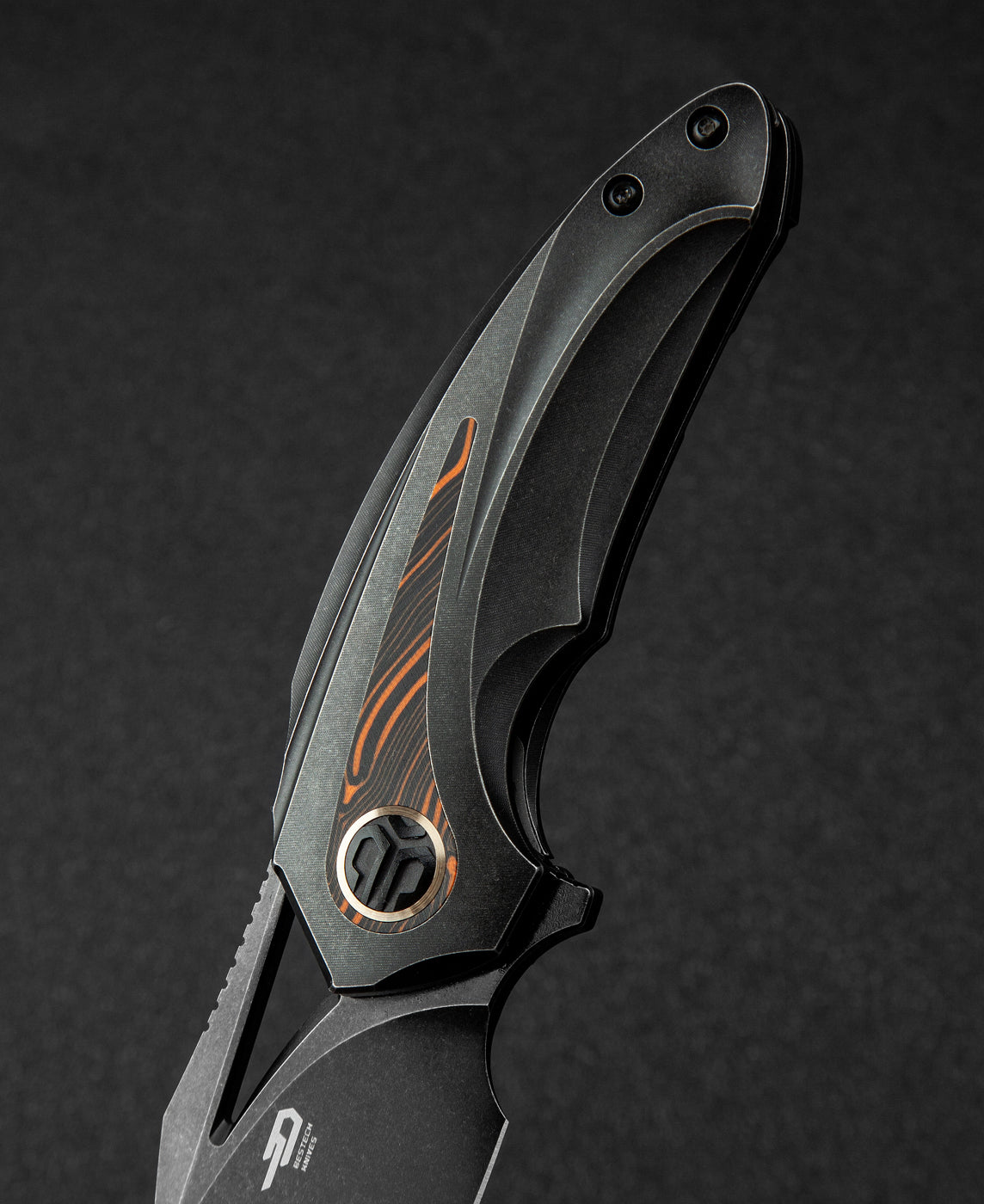 Bestech Nuke BT2107E handle detail – black G10 and orange G10 inlay texture on titanium