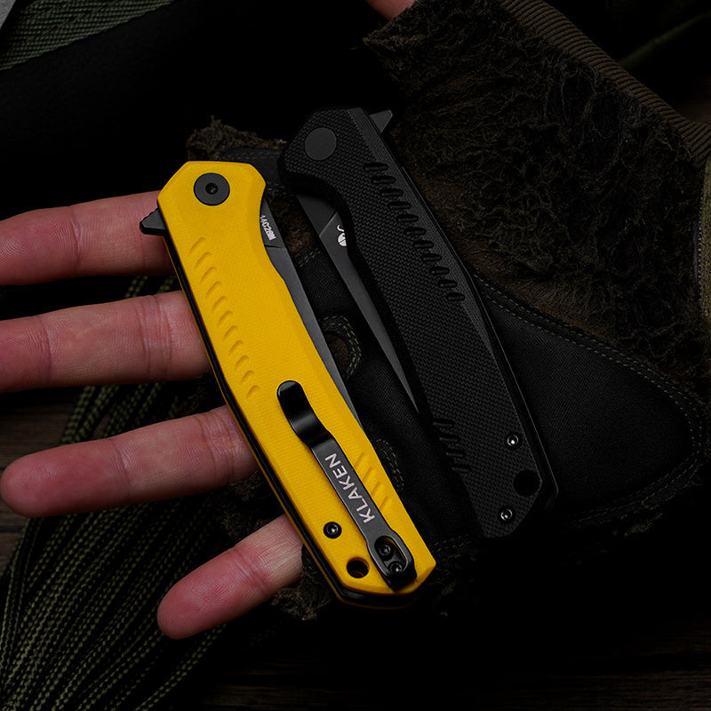 Klaken J336 The Flint J336-YellowG10-BlackBlade yellow G10 handle shown closed in hand