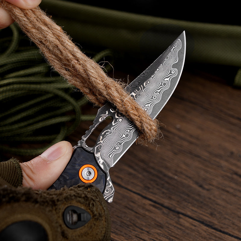 Klaken J385 Wraith J385-BlackBlueShreddedCarbon open position showing Damascus steel blade
