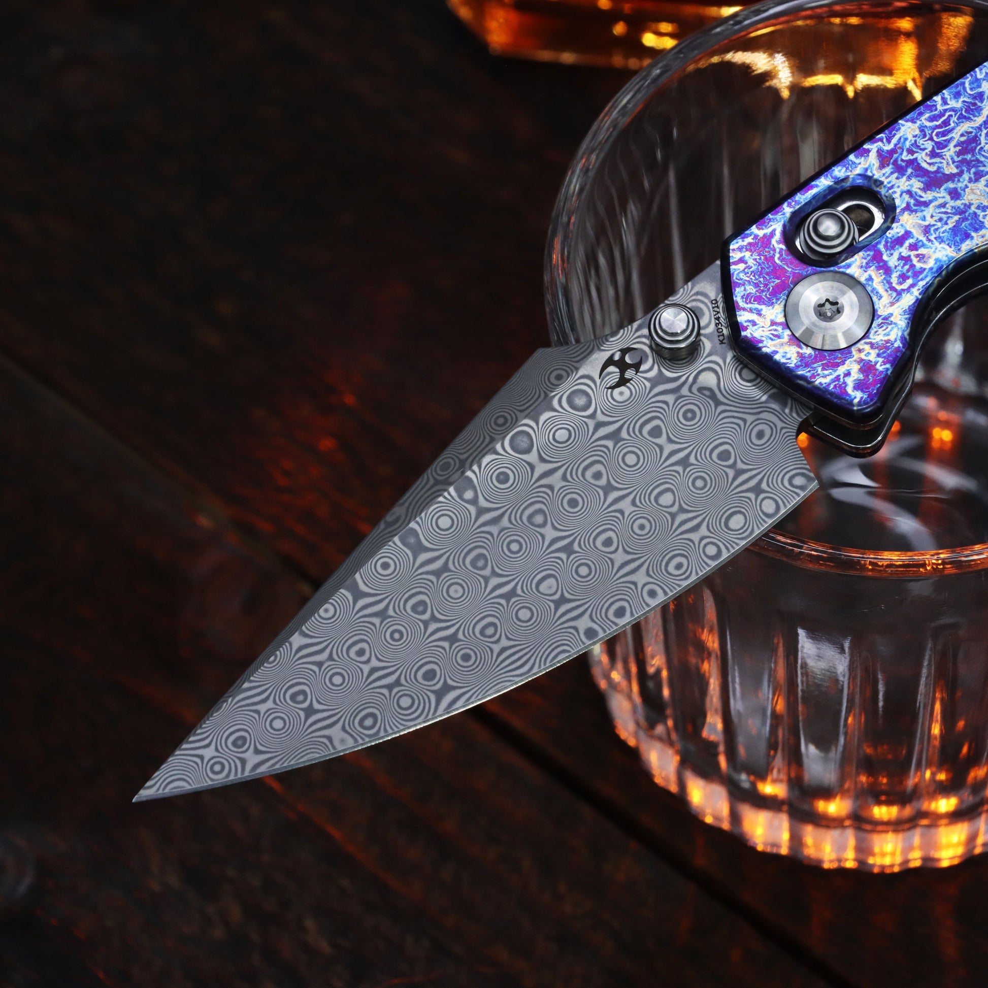 Kansept Fenrir K1034V10 open position showing acid etched Damascus harpoon blade
