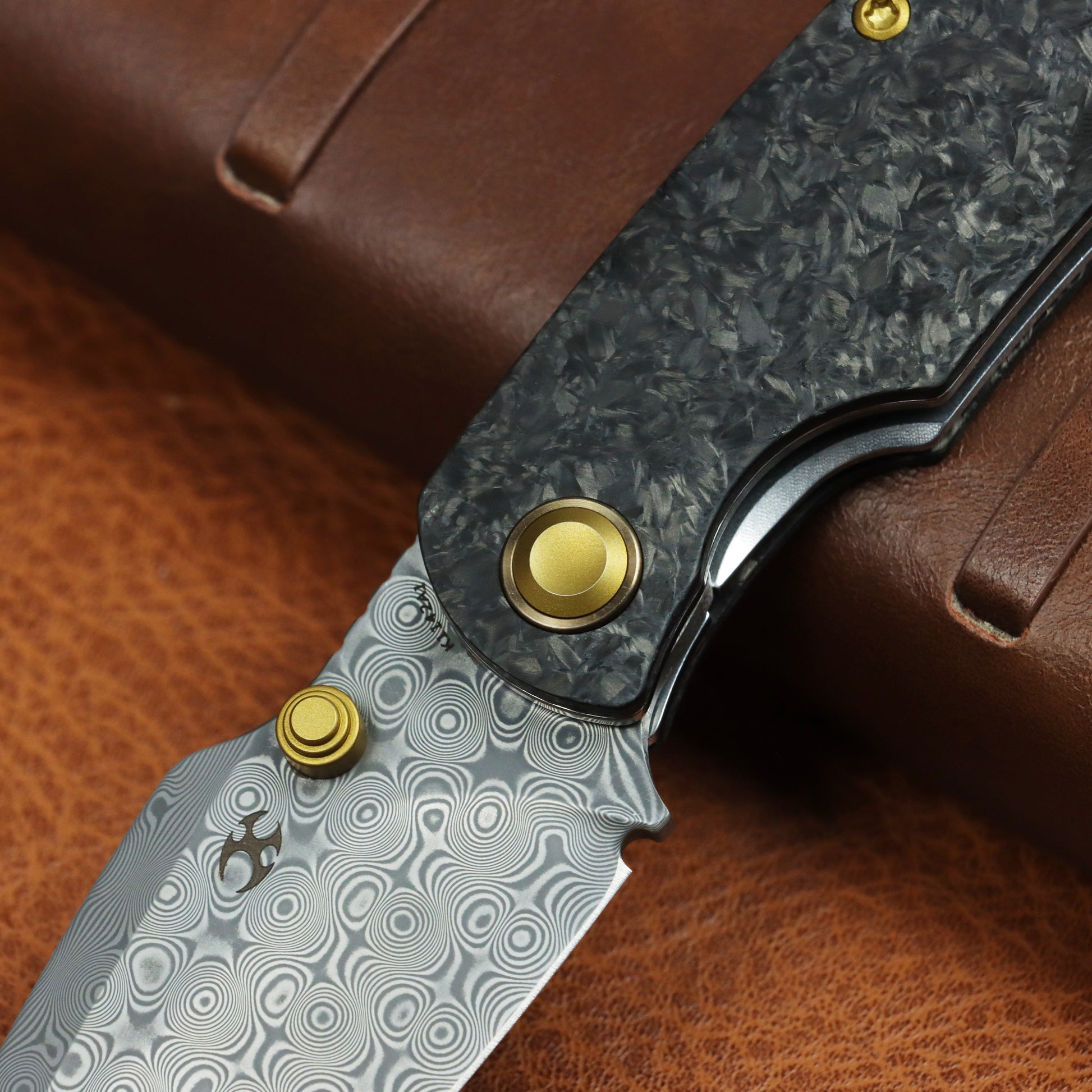 Kansept Falk K1142A1 open position showing Damascus Drop Point blade