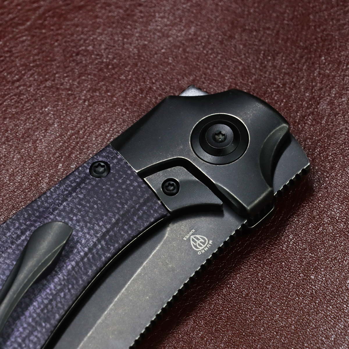 Kansept Pluto K3129A2 open position showing blackwash titanium and purple micarta