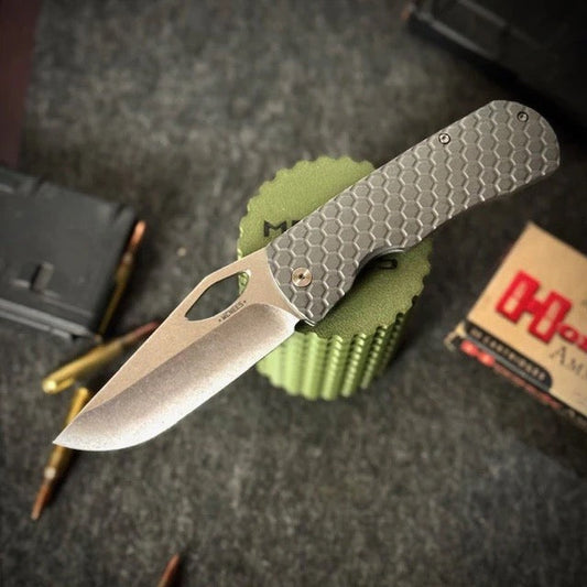 McNees Dixon open, showing the 3.75″ satin stonewash MagnaCut drop point blade and honeycomb milled titanium handle