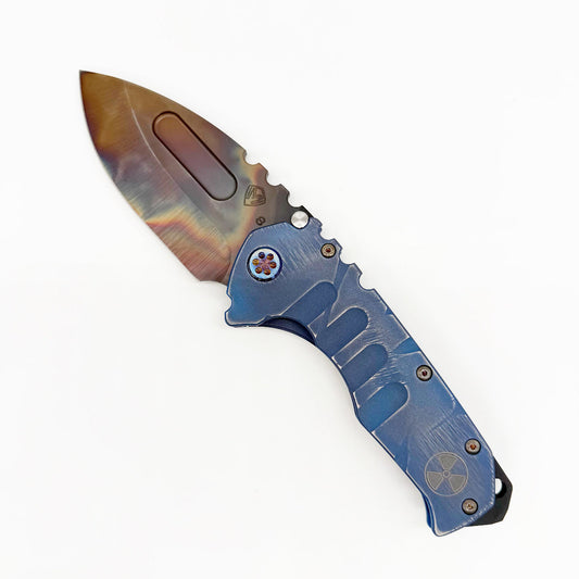 Medford Praetorian T open, showing the 3.875″ S35VN Vulcan drop point blade and Blue Fallout anodized titanium handle