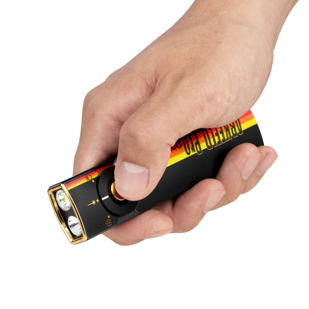 Olight Arkfeld Pro Racing Stripes held in hand showing its flat EDC profile and thumb-reach selector
