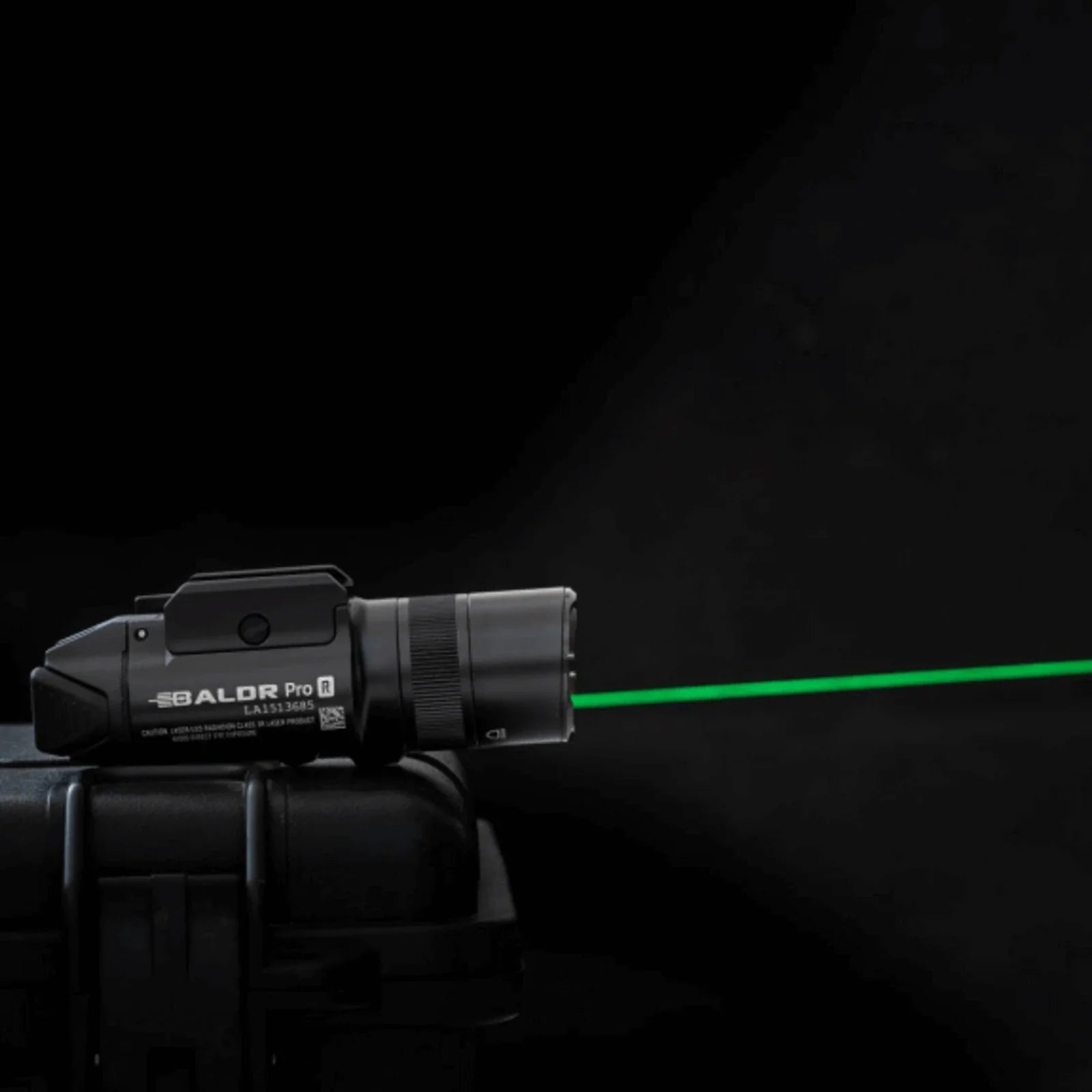 Olight Baldr Pro R Black projecting its green laser beam in the dark