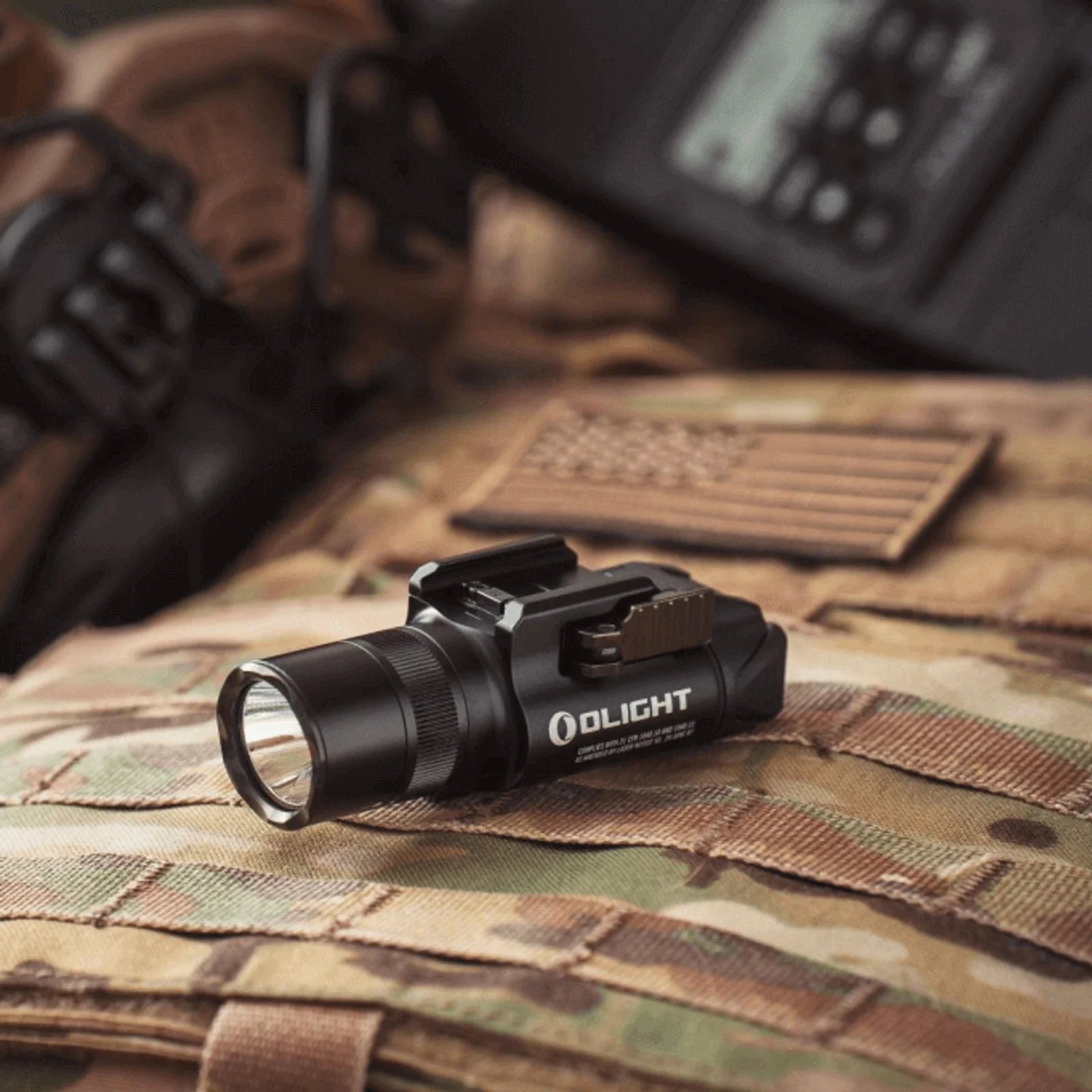 Olight Baldr Pro R Black shown mounted on tactical gear