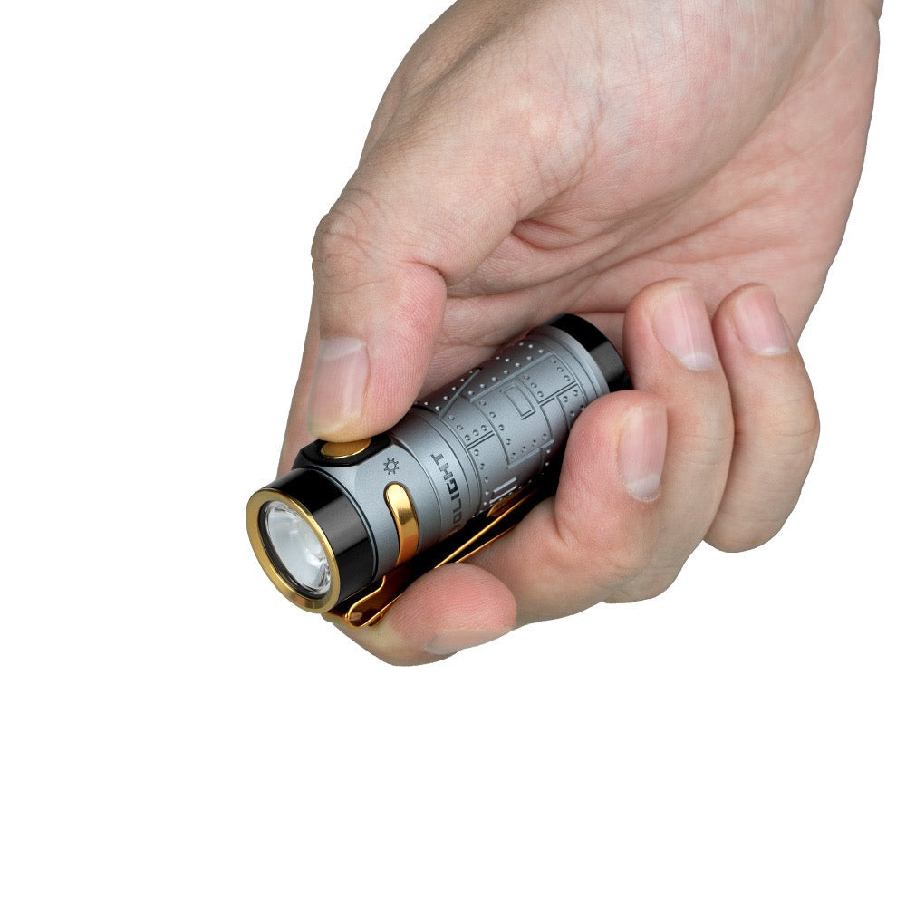 Olight Baton 4 Premium Fighter Pilot held in hand showing compact EDC pocket size