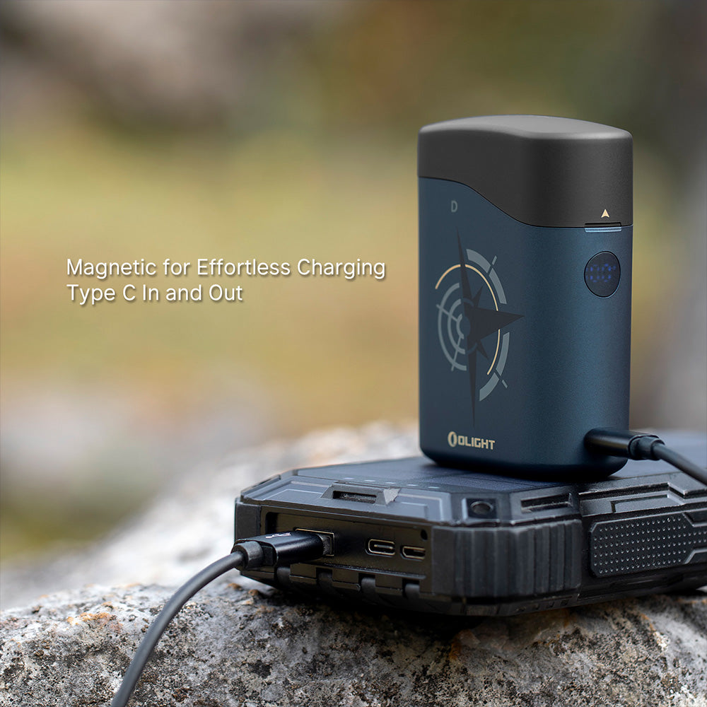 Olight Baton 4 Premium Guidance charging case magnetic charging with USB-C in and out, shown outdoors on rock
