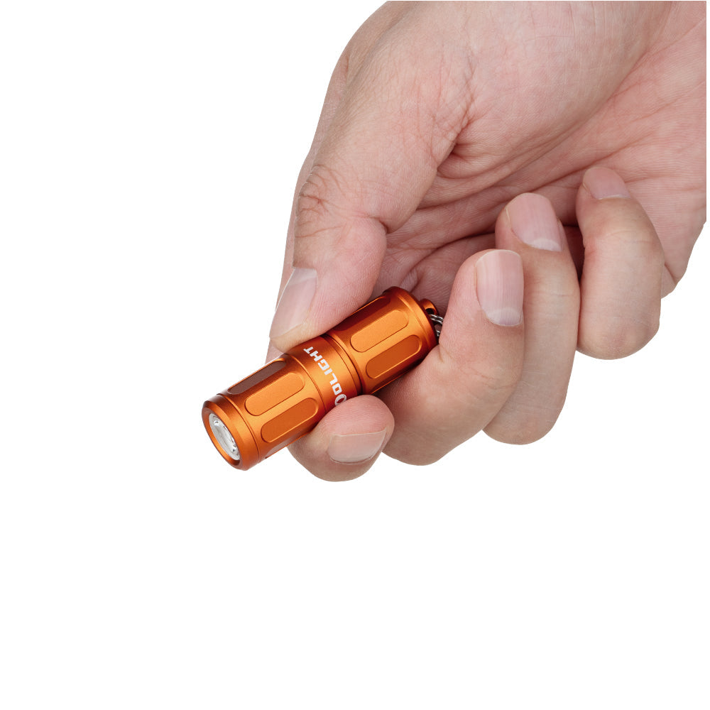 Olight i1R 2 Pro Capsule Orange held in hand showing its keychain size