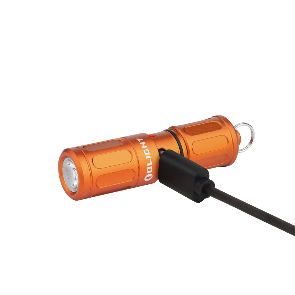 Olight i1R 2 Pro Capsule Orange connected to a USB-C charging cable