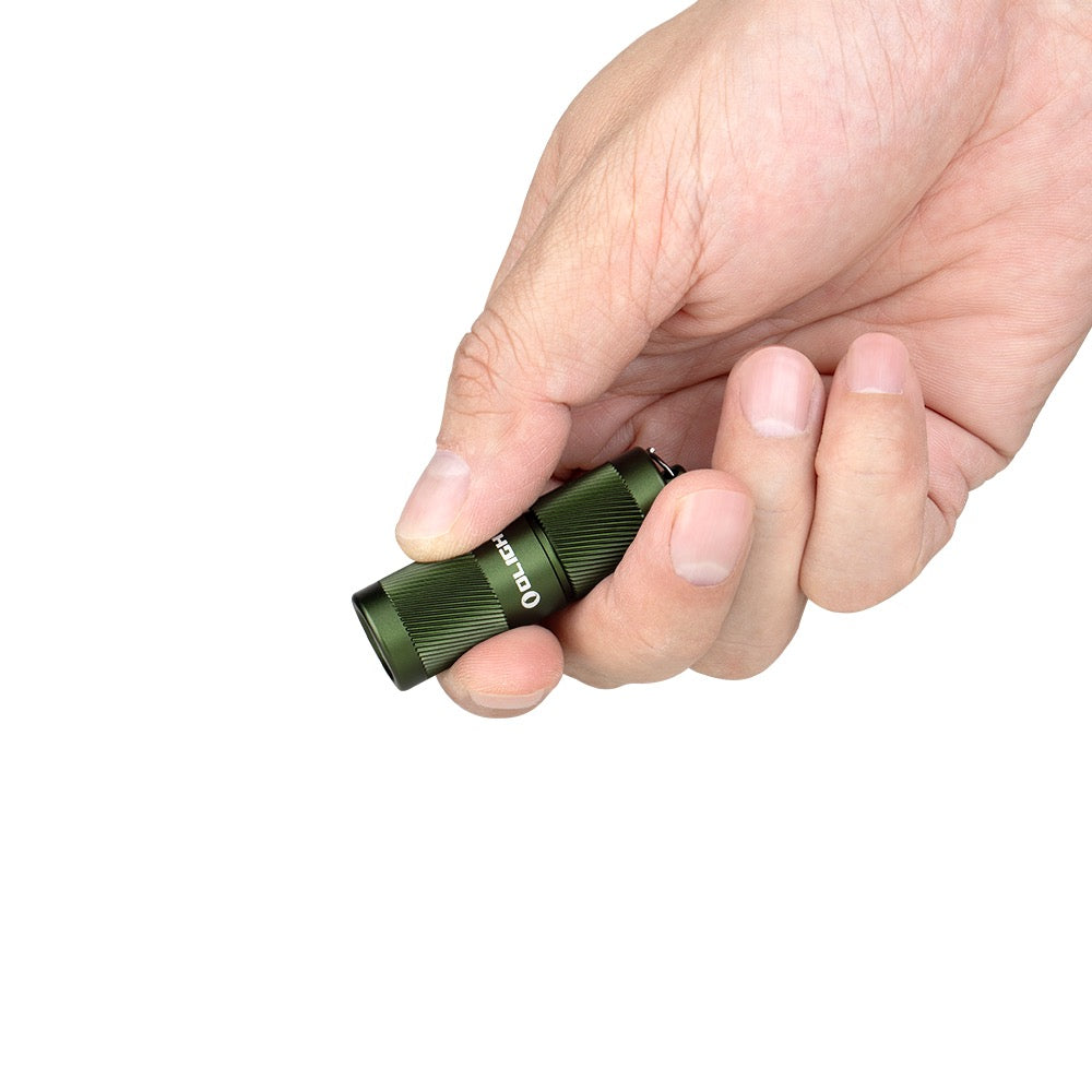 Olight i1R 2 Pro Green held in hand showing its keychain size
