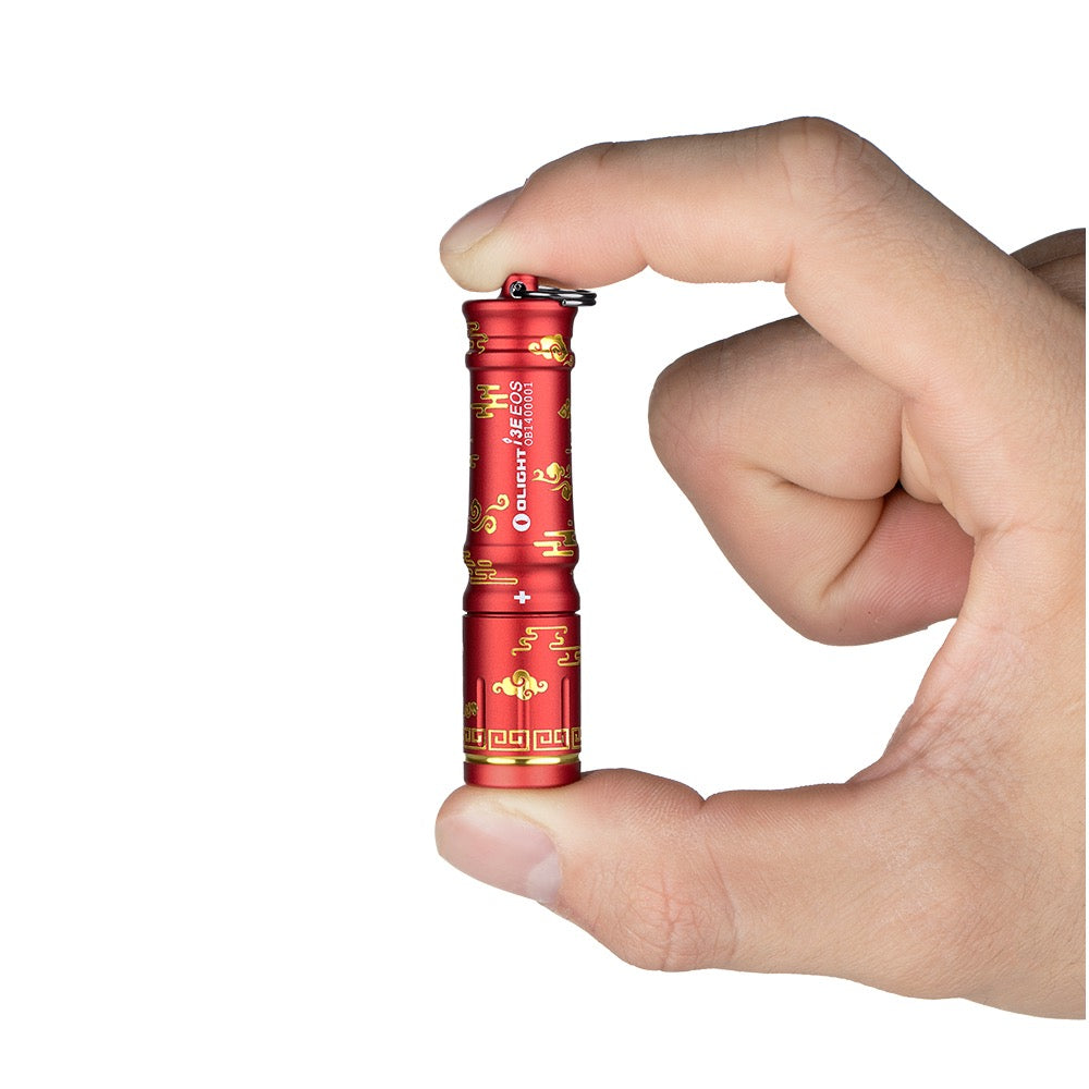 Olight i3E EOS Auspicious Clouds held between fingers showing its keychain size