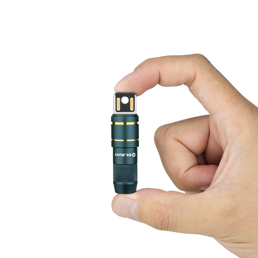 Olight imini 2 Dream Blue held between fingers showing its keychain size