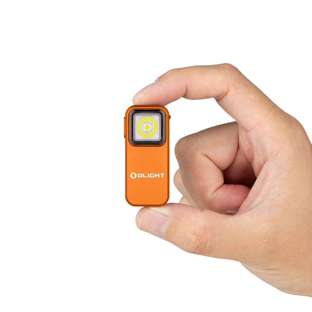 Olight Oclip Orange held in hand showing its compact 1.9 inch clip-on size