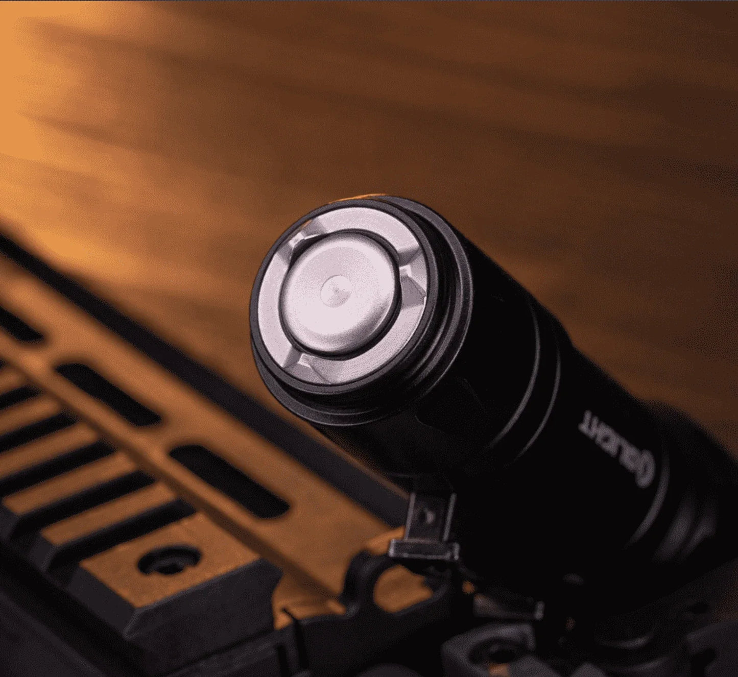 Olight Odin GL Mini mounted on a rail, showing the lock button and secure fit