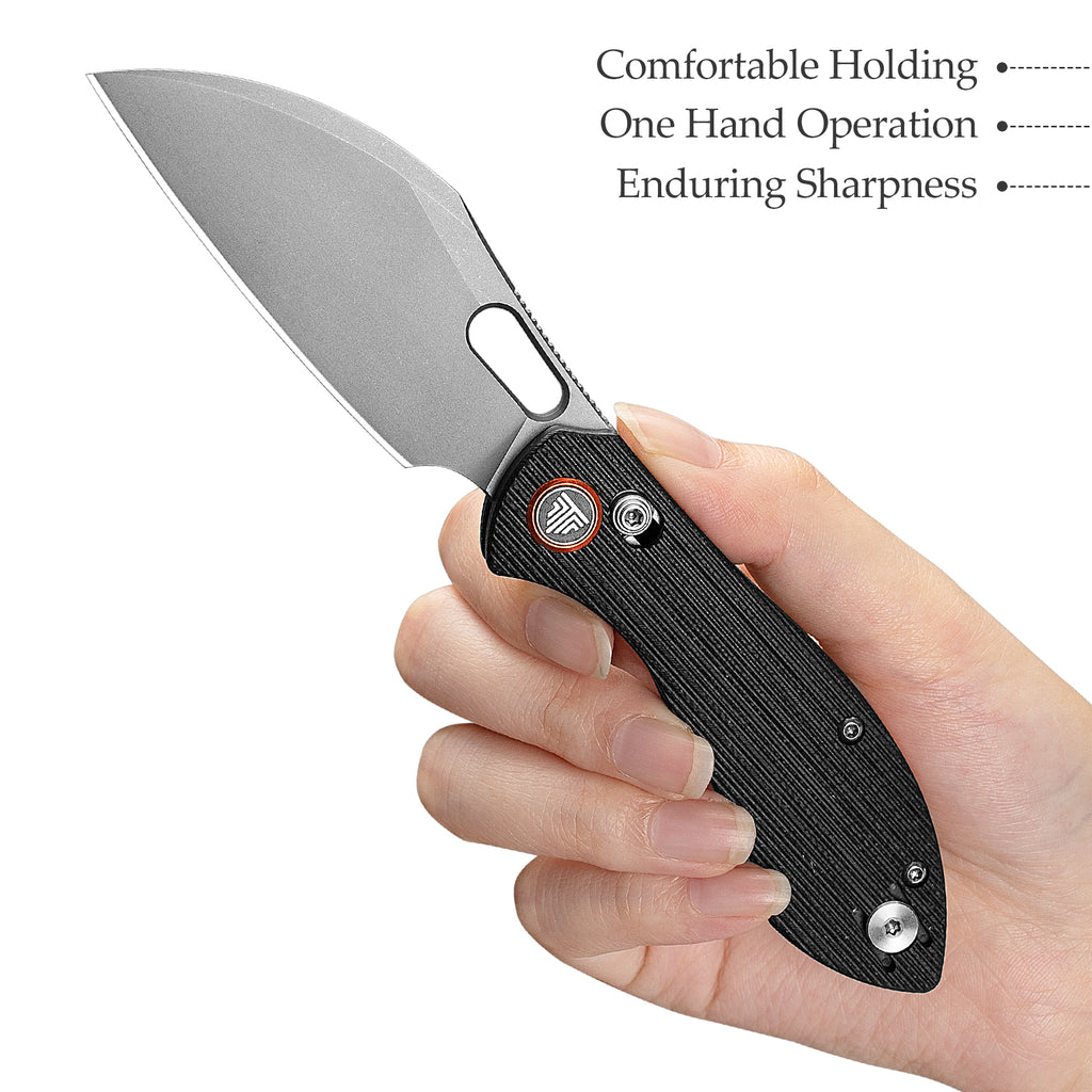 TRIVISA Batwing-BG JM10S-BG-14 held in hand showing ergonomic G10 grip