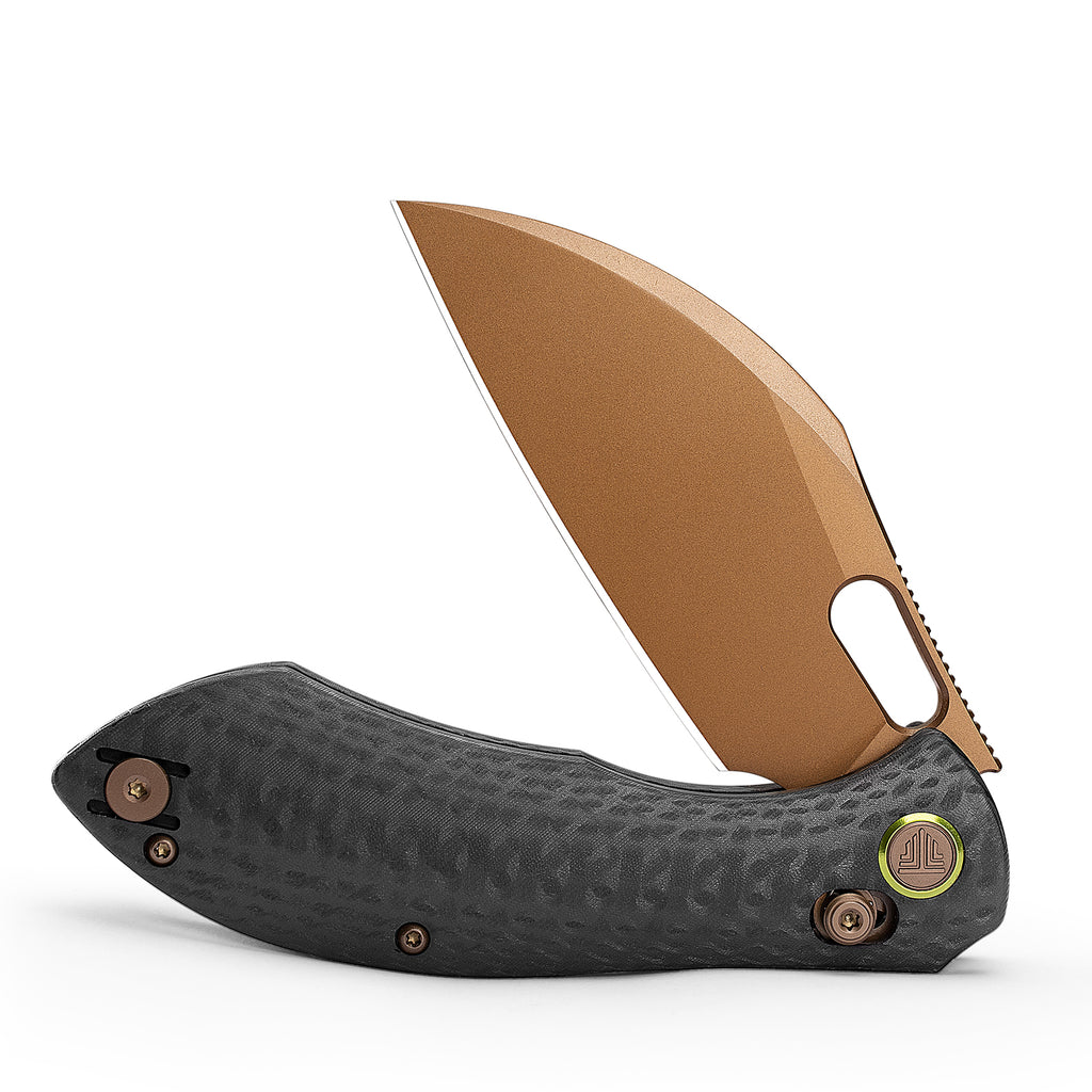 Hand holding bronze and black lock knife showing ergonomic grip and blade