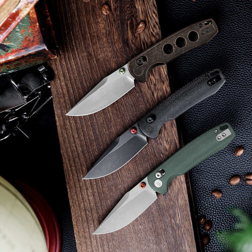 Collection of tactical folding knives with textured handles and clip point blades