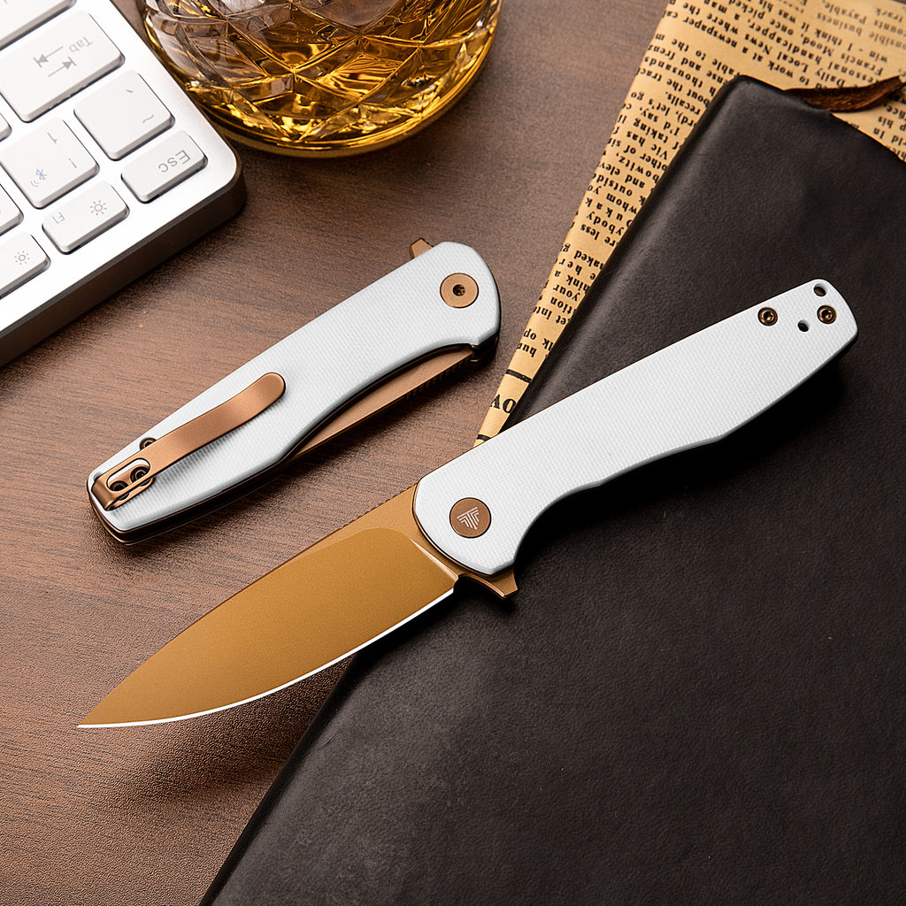 TRIVISA Hummingbird-WG JM07-WG-14 2.9 inch drop point liner lock knife with white G10 handle and rose gold accents