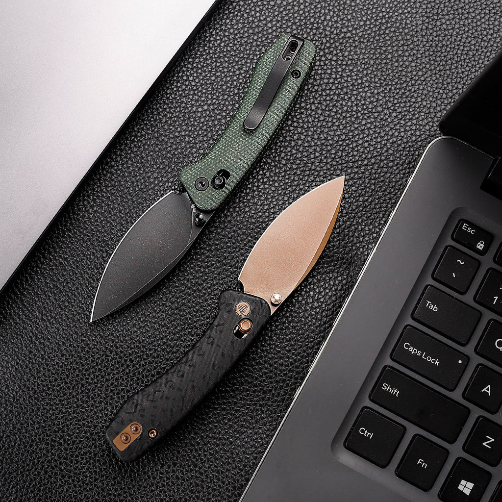 Green and black folding knife with drop point blade and textured handle