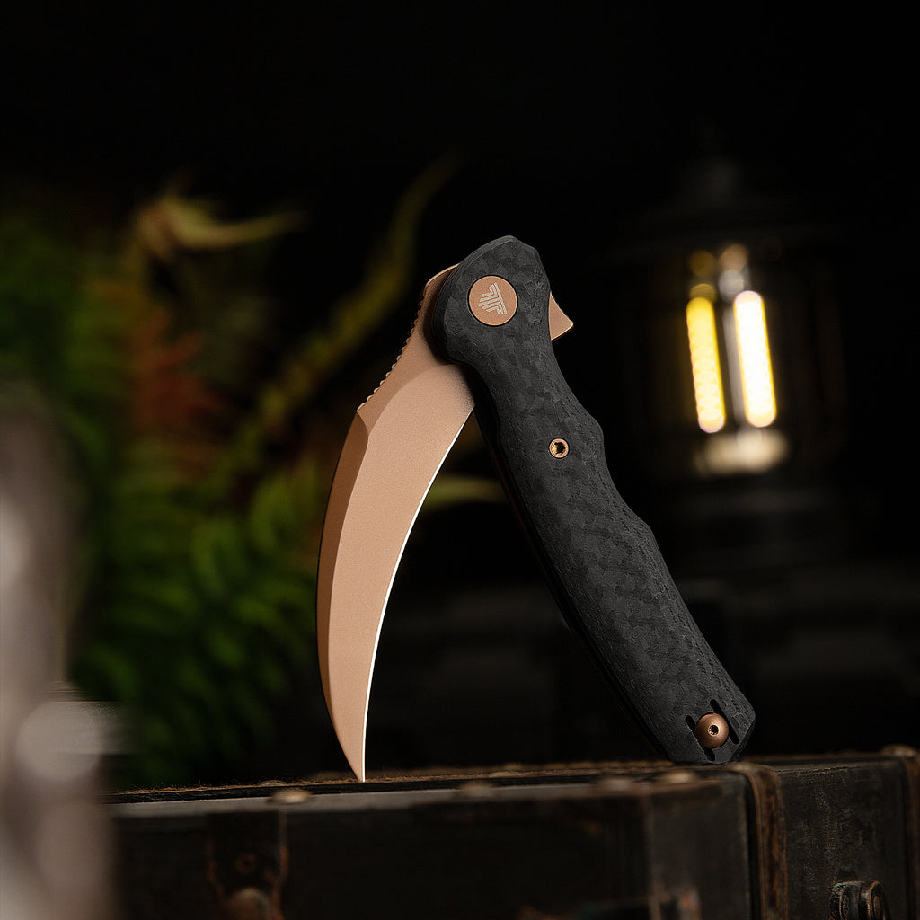 Close-up of TRIVISA Lacerta-CG folding knife with bronze blade and textured handle