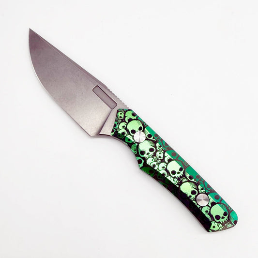 Vero Engineering Myelin SW Skull front view – 3.6″ stonewashed M390 drop point small EDC fixed blade knife with green skull laser-anodized titanium handle