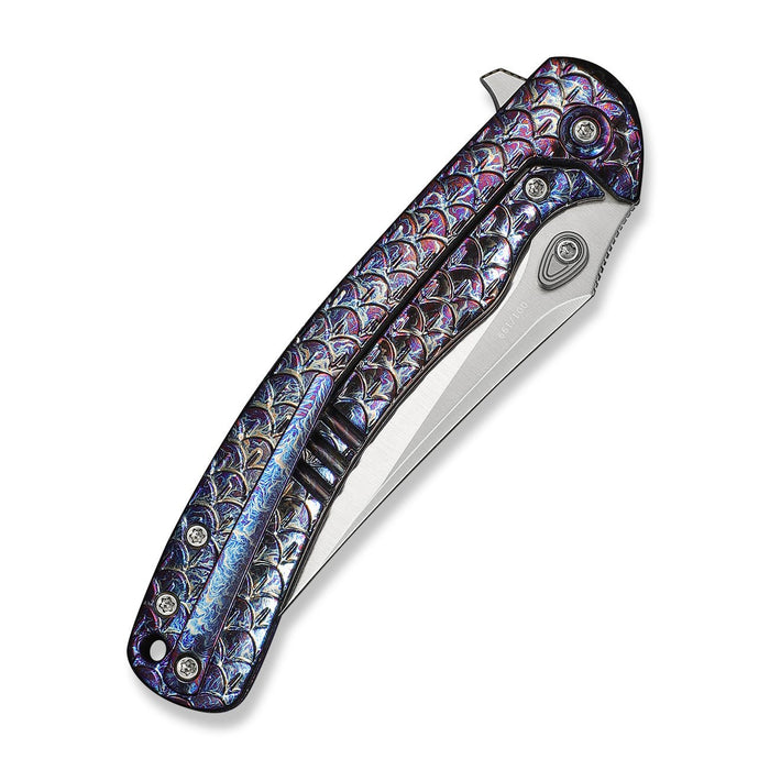 Close-up of WE Knife Dracarys handle with fish scale pattern and metallic accents